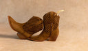 Pair of brown cowboy boots with patterned soles on a beige background