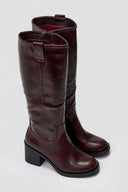 Pair of brown knee-high boots on a light gray background